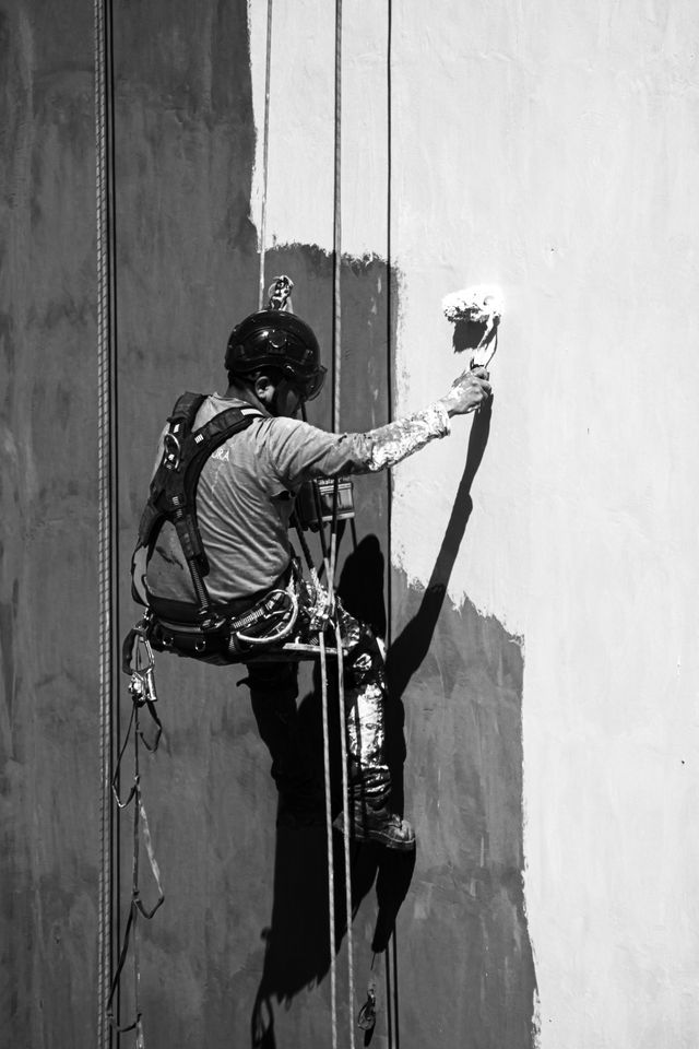 Person waterproofing the wall